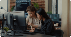 A man and a woman on a computer